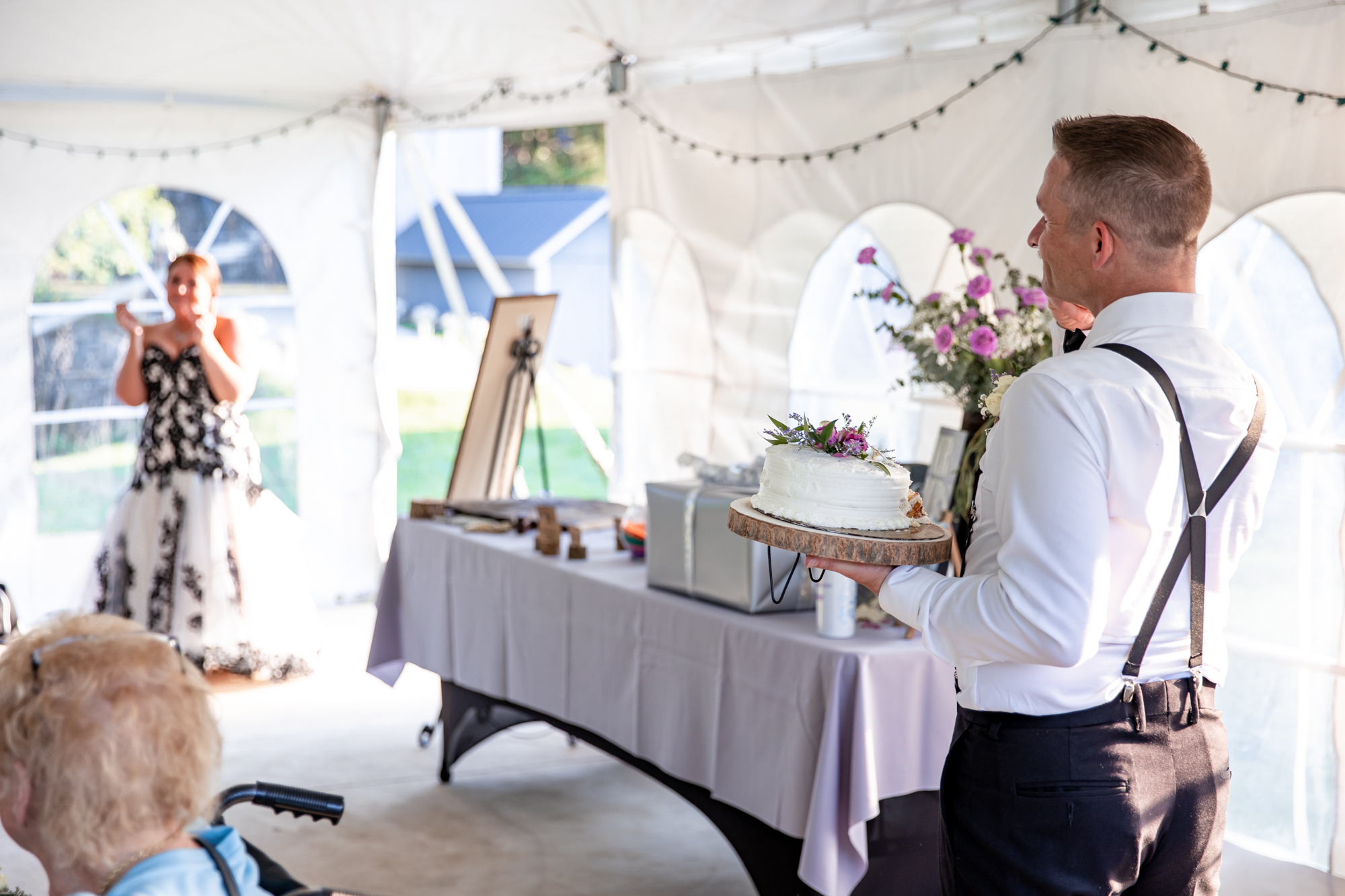 cake cutting at an outdoor tent reception