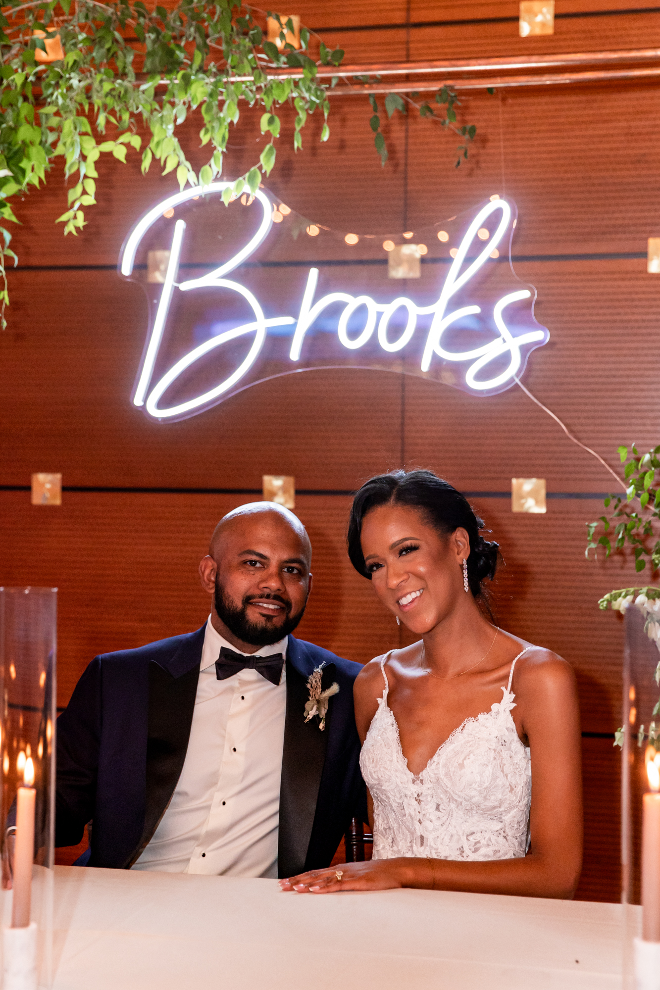 bride and groom under a neon sign at a kimmel center wedding reception