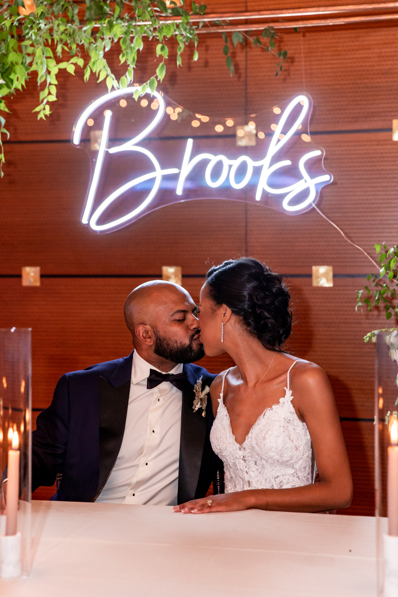 bride and groom under a custom neon sign at a kimmel center wedding reception