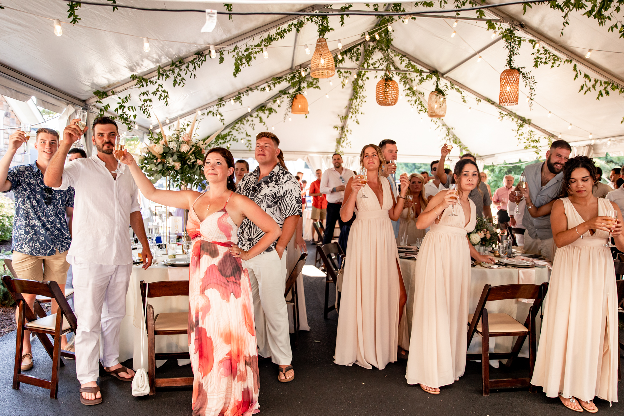 guests toasting at a private beach wedding reception