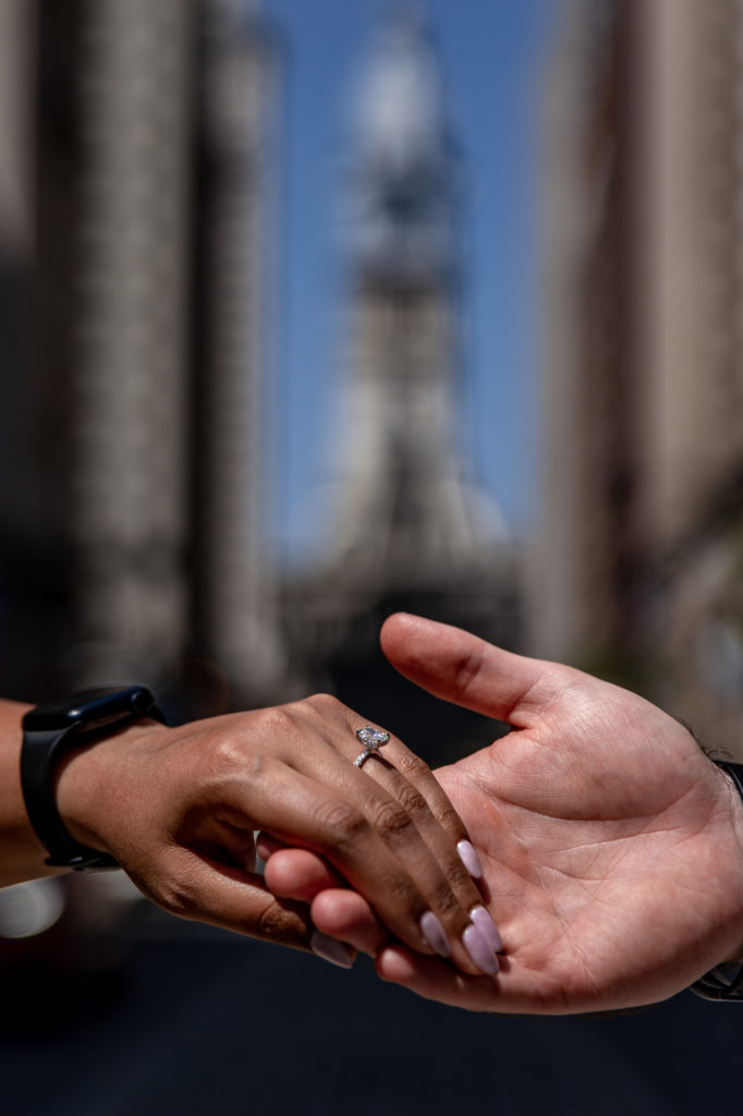 an engagement ring in front of city hall
