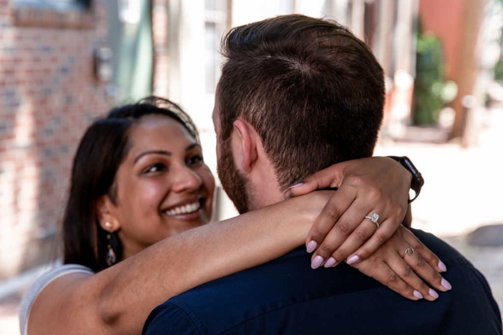 a newly engaged couple on a side street in center city philadelphia after a city hall proposal