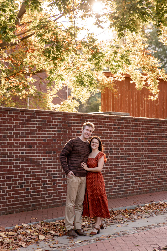 a couple has a picnic during a photoshoot in the backyard of carpenter's hall
