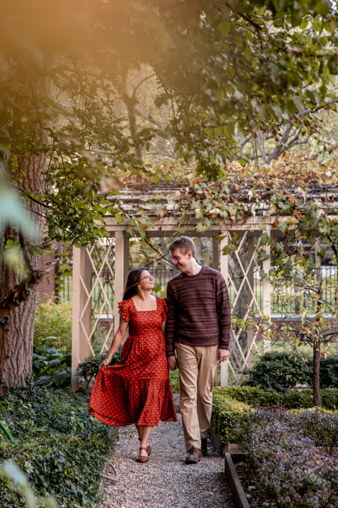 a couples poses for photos in a garden in old city philadelphia