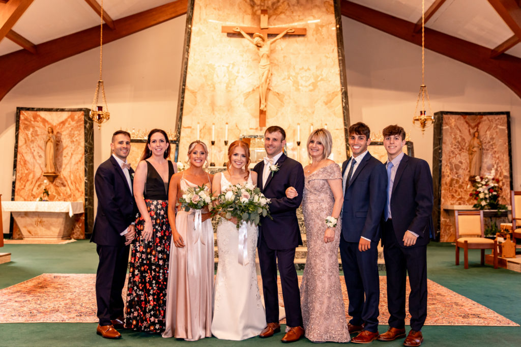formal family photos following a catholic wedding ceremony