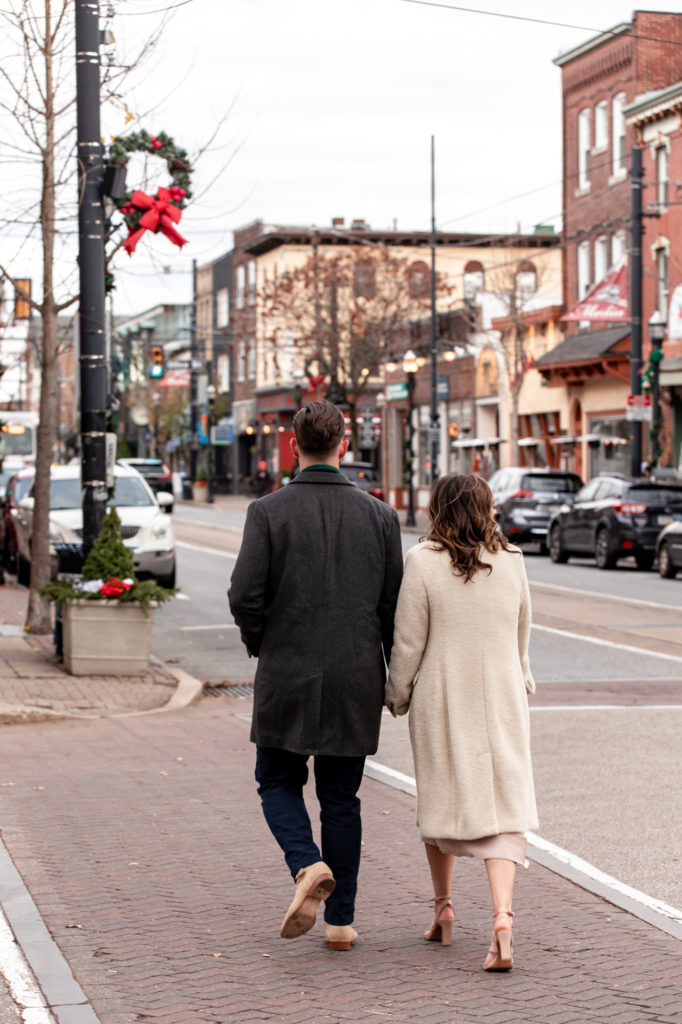 a couple takes photos to celebrate their engagement in downtown media, pa