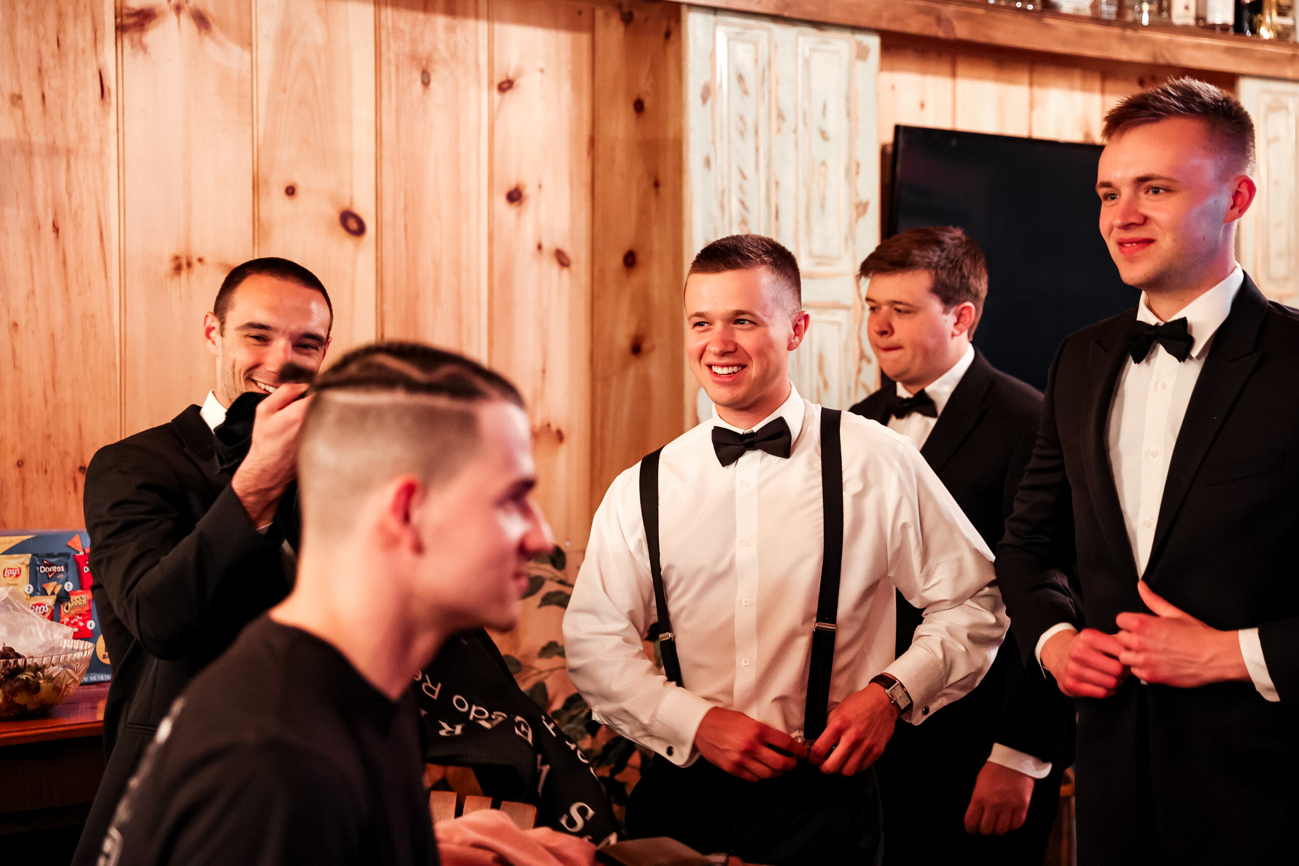 groom getting ready for wedding with groomsmen at white chimneys estate