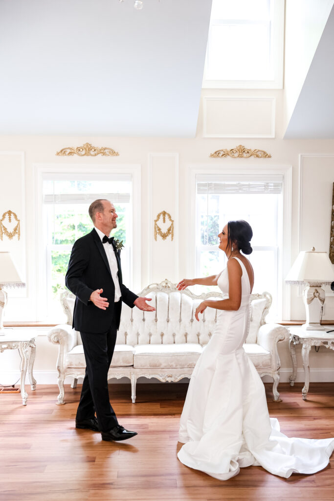 bride shares first look with her father in the bridal suite at white chimneys estate wedding venue