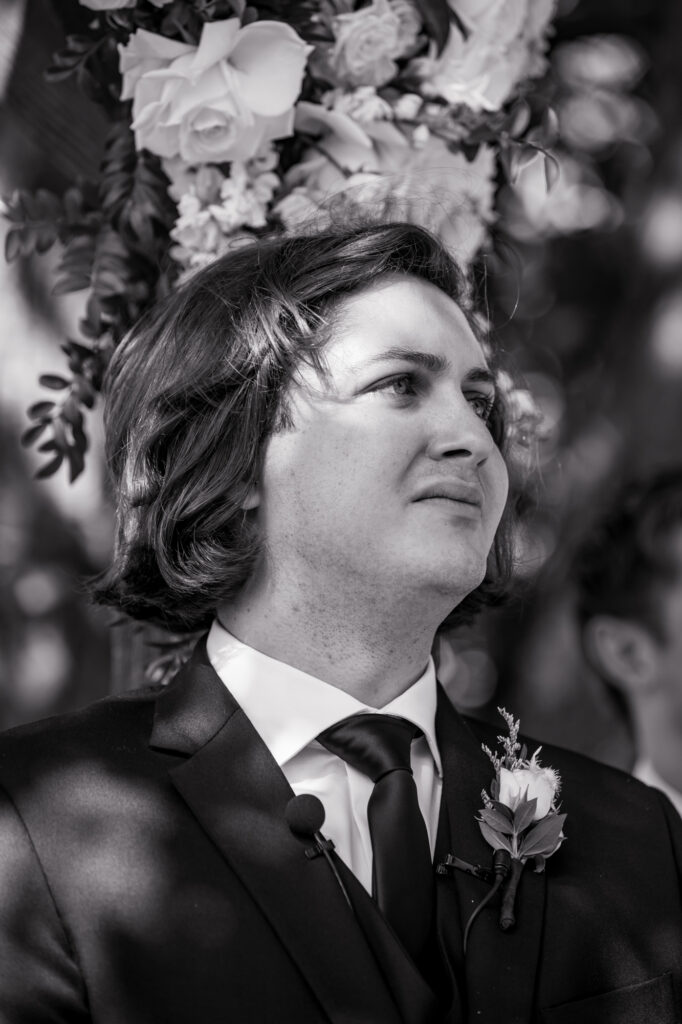 groom crying in tears watching the bride walk down the aisle