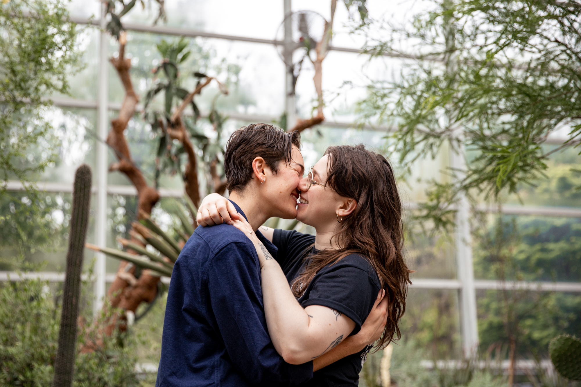 two women newly engaged at the brooklyn botanic garden in nyc