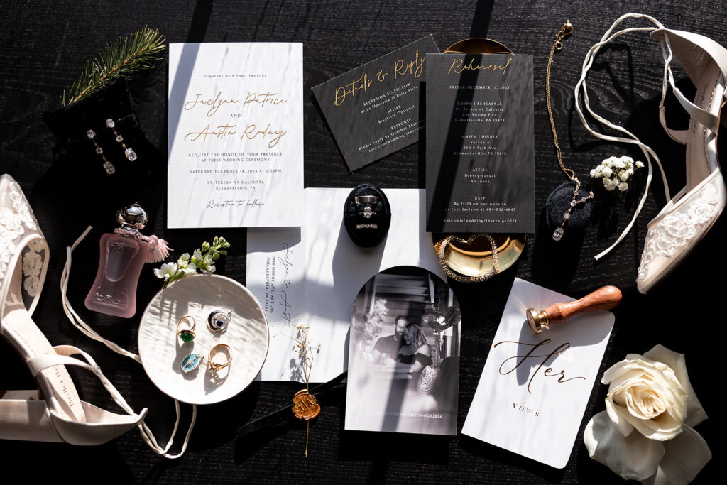 black, white and gold details fill a detail flat lay photo for a december wedding