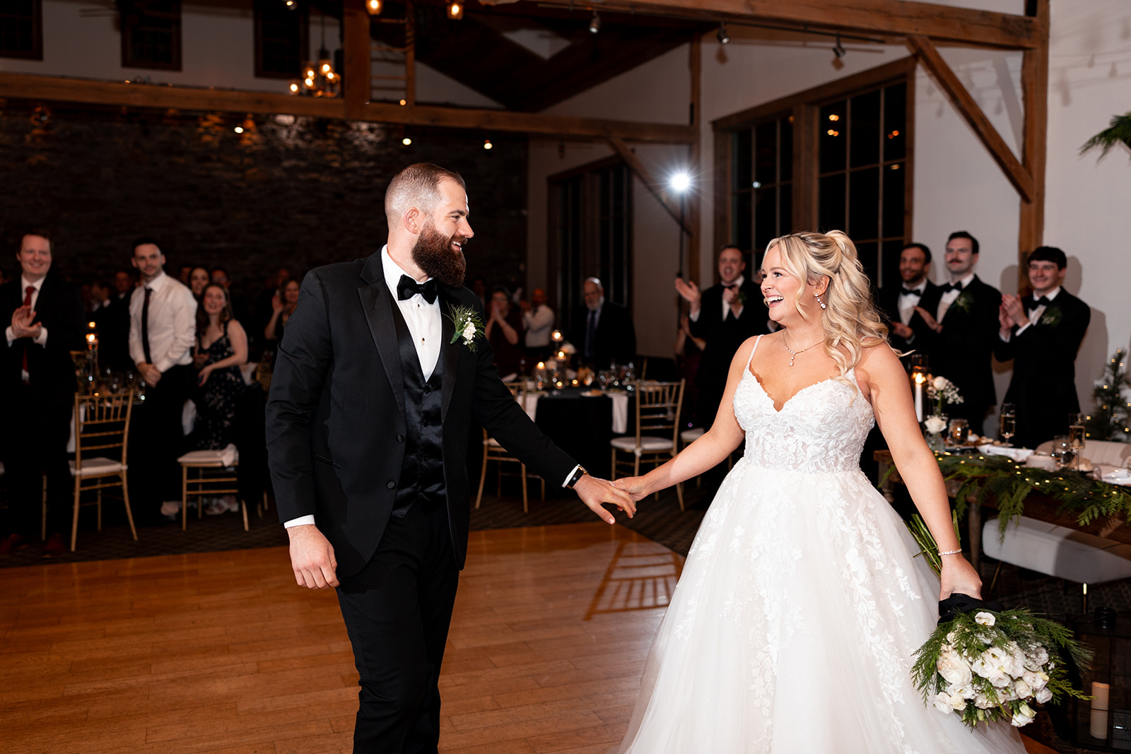 bride and groom smiling as they enter their wedding reception at la massaria at bella vista